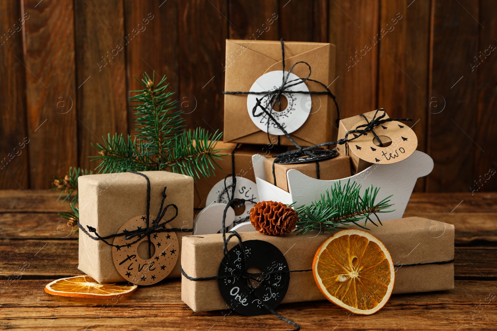 Photo of Gifts for Christmas advent calendar and festive decor on wooden table