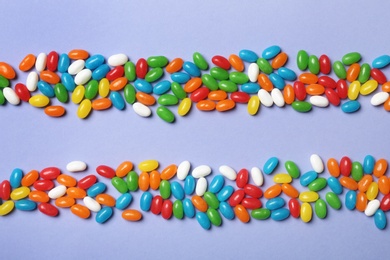 Photo of Bright jelly candies on color background, flat lay