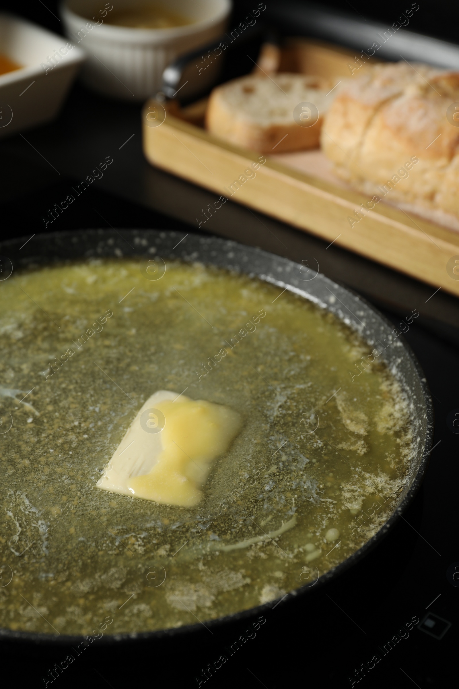 Photo of Melting butter in frying pan on table