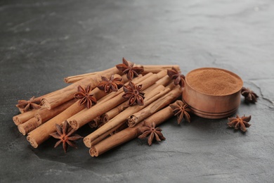 Aromatic cinnamon and anise on black table