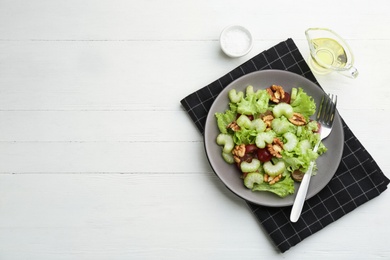 Delicious fresh celery salad served on white wooden table, flat lay. Space for text