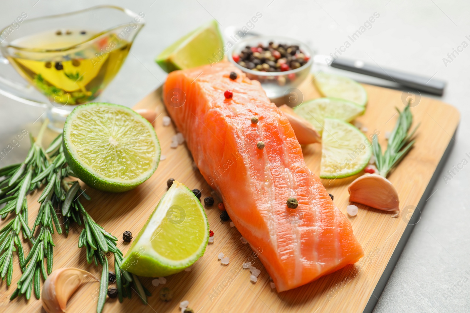 Photo of Fresh salmon and ingredients for marinade on wooden board