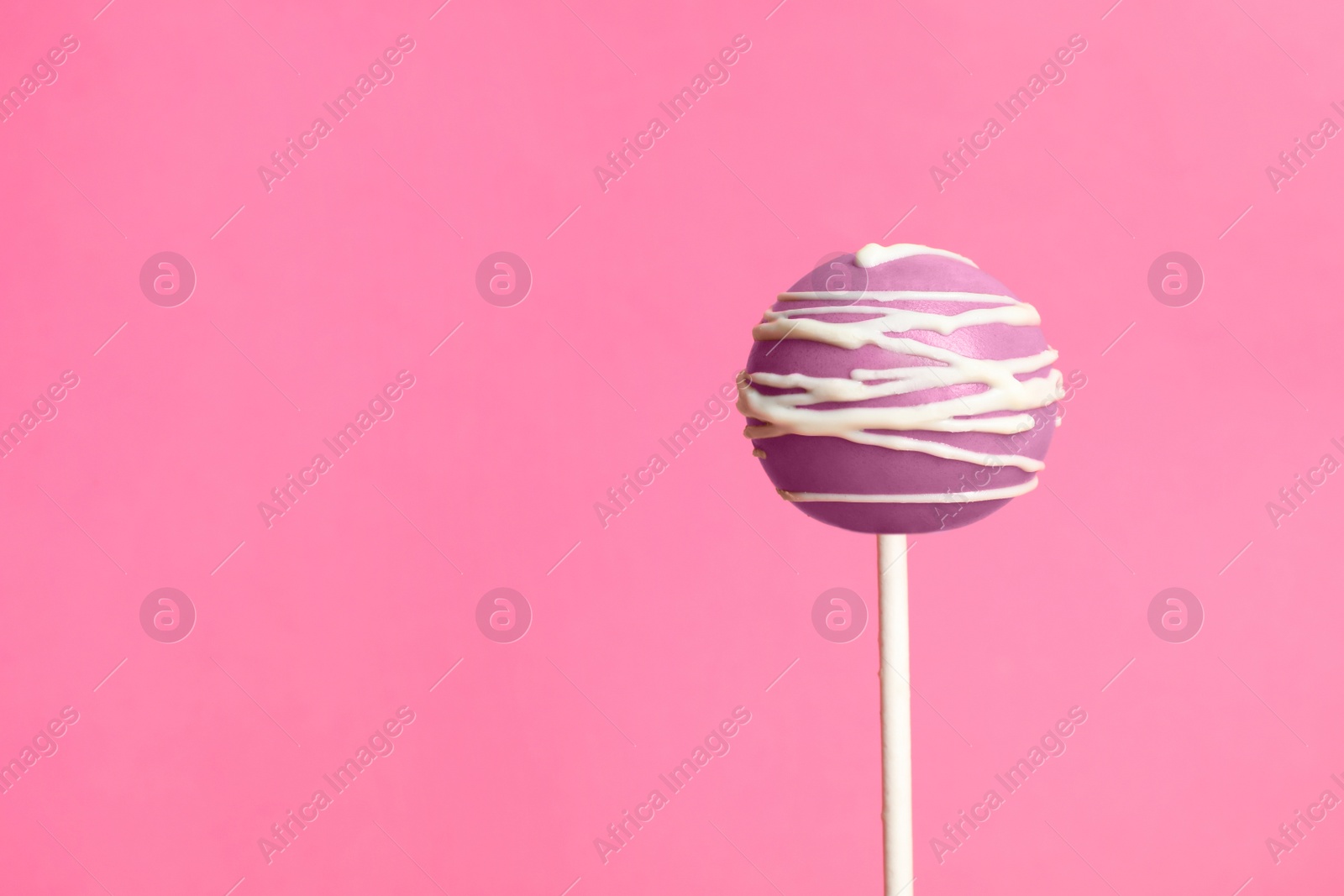 Photo of Bright delicious cake pop on color background. Space for text