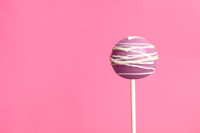 Bright delicious cake pop on color background. Space for text