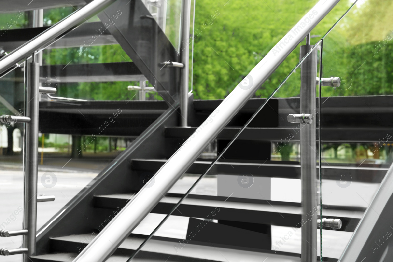 Photo of Modern stairs with metal handrailings on city street