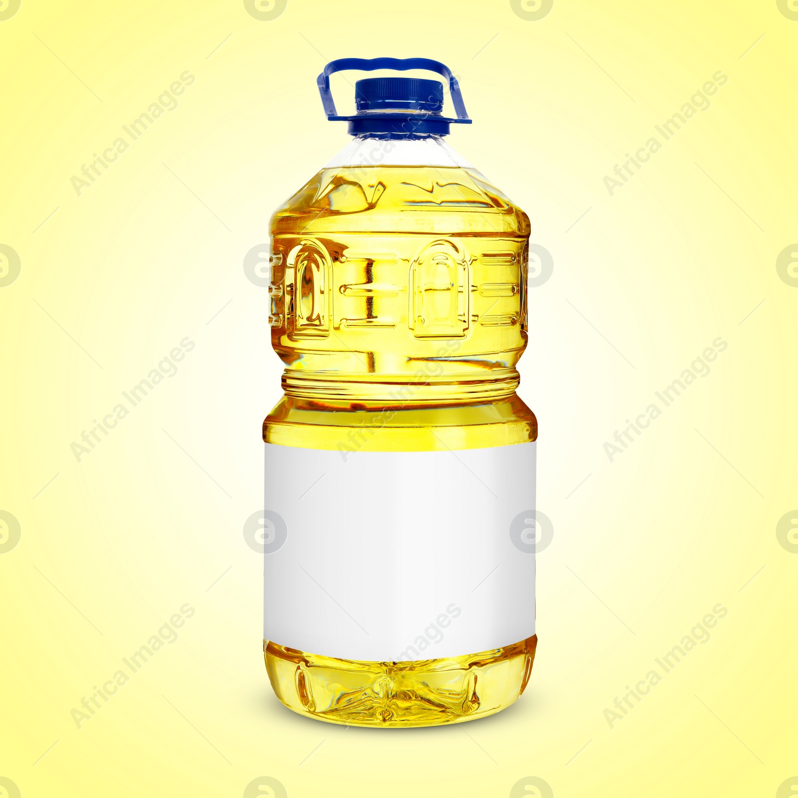 Image of Cooking oil in plastic bottle with empty label on light yellow background. Mockup for design