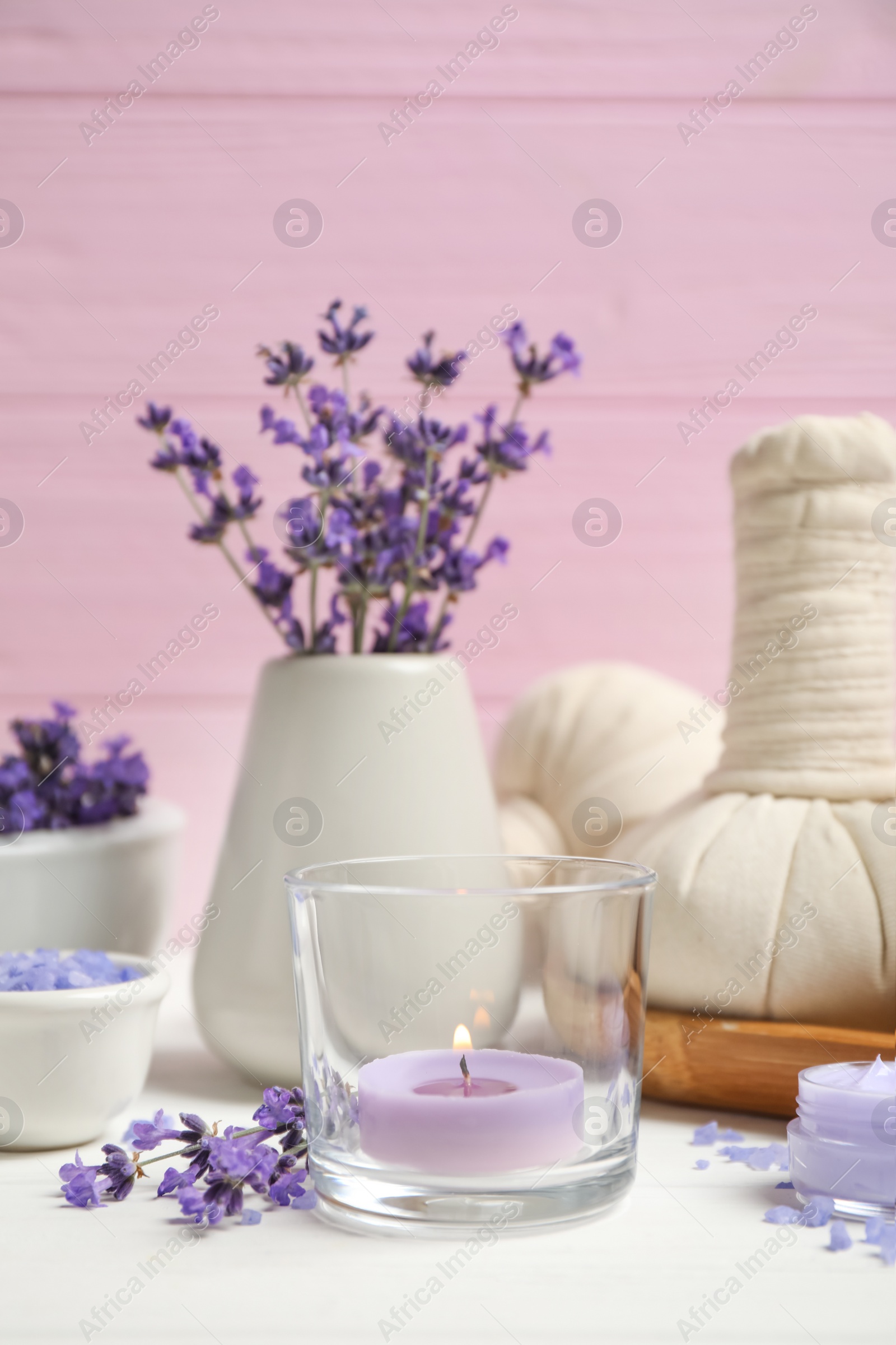 Photo of Cosmetic products and lavender flowers on white wooden table