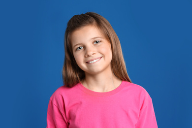 Photo of Portrait of preteen girl on blue background
