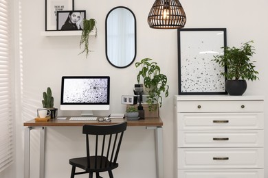 Photo of Cozy workspace with computer on wooden desk at home
