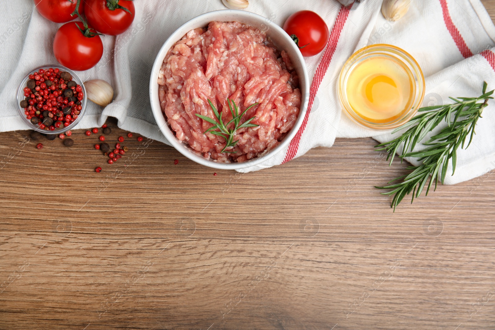 Photo of Raw chicken minced meat and ingredients on wooden table, flat lay. Space for text