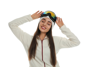 Photo of Woman wearing fleece jacket, hat and goggles on white background. Winter sport clothes