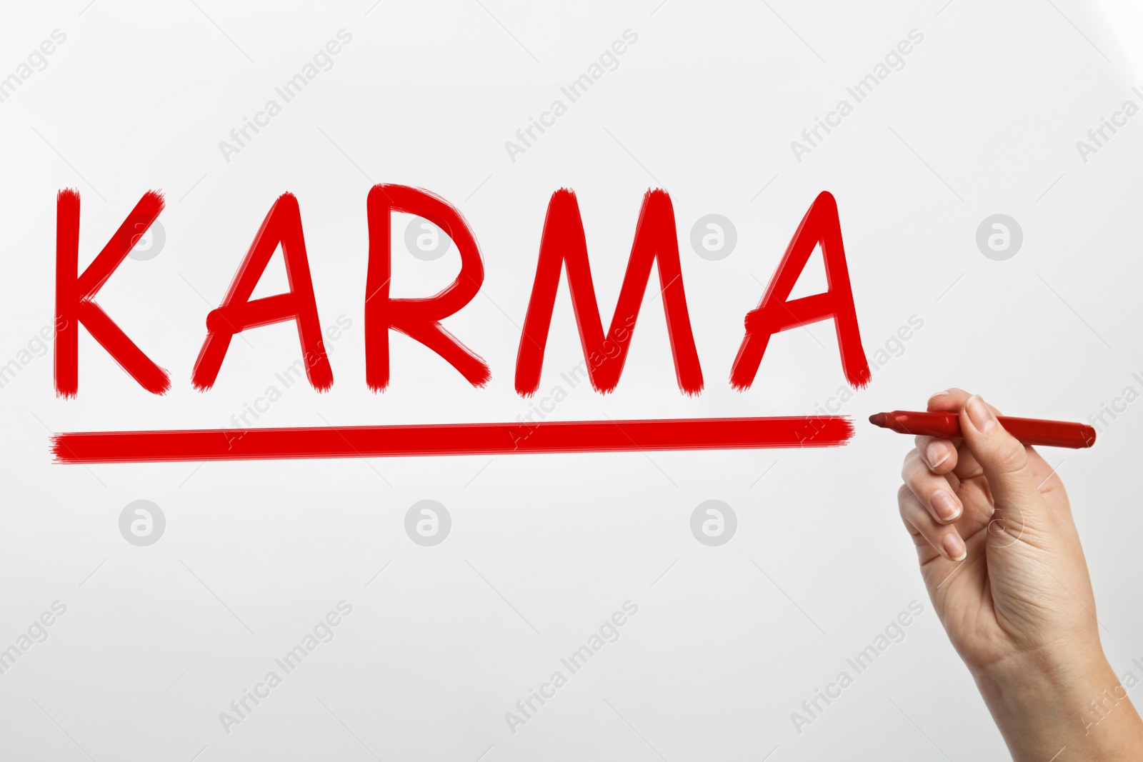 Image of Woman writing word KARMA on glass against white background, closeup