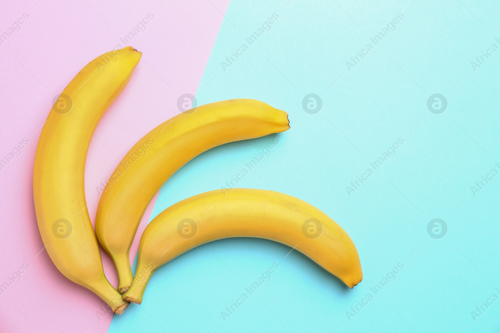 Photo of Ripe tasty bananas on color background, flat lay with space for text