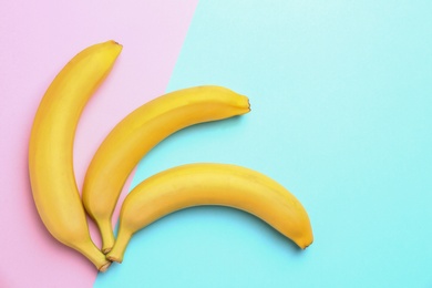 Ripe tasty bananas on color background, flat lay with space for text