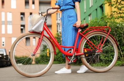 Photo of Young woman with bicycle in city, closeup