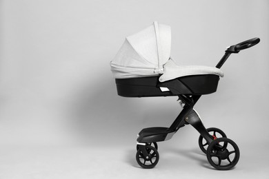 Baby carriage. Modern pram on grey background, space for text