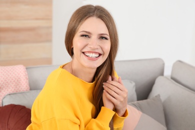 Photo of Portrait of young woman laughing at home