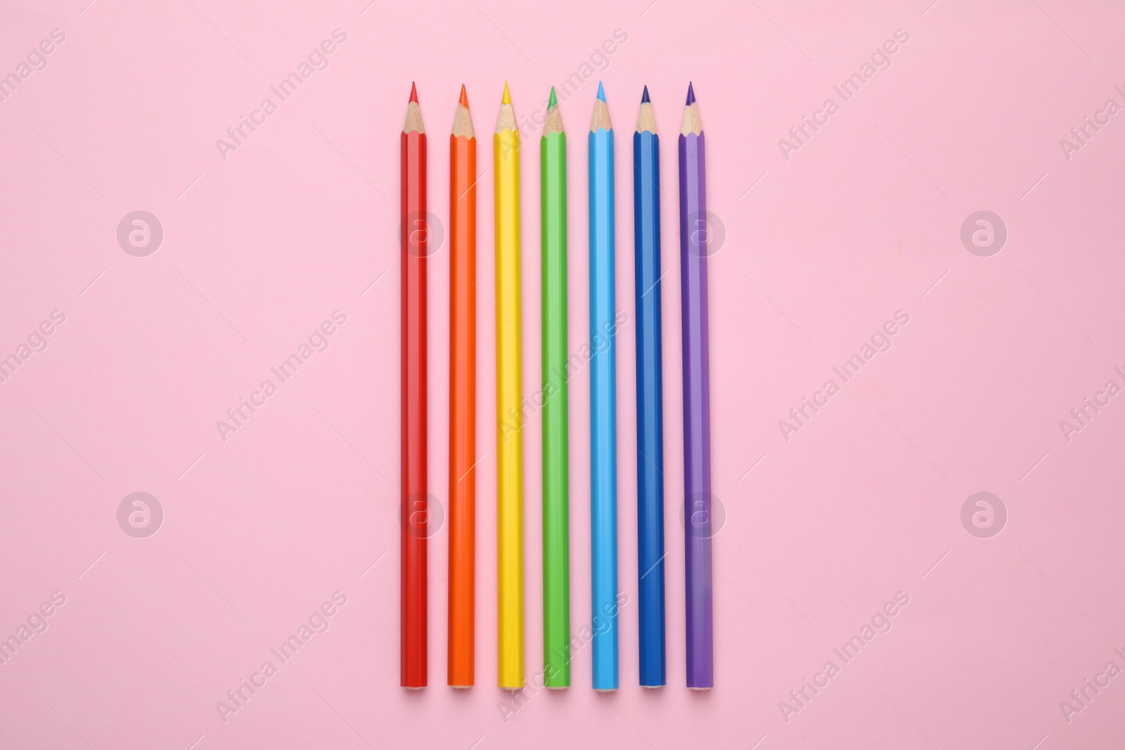 Photo of Colorful wooden pencils on pink background, flat lay