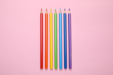 Photo of Colorful wooden pencils on pink background, flat lay