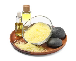 Yellow sea salt in bowl, spa stones and cosmetic products isolated on white