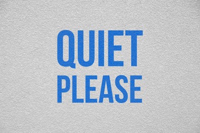 Illustration of Phrase Quiet Please on white textured wall