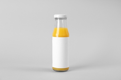 Bottle with delicious fresh juice on light background