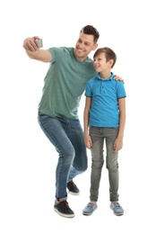 Photo of Dad and his son taking selfie on white background