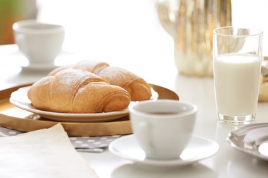 Photo of Tasty breakfast with fresh croissants on table