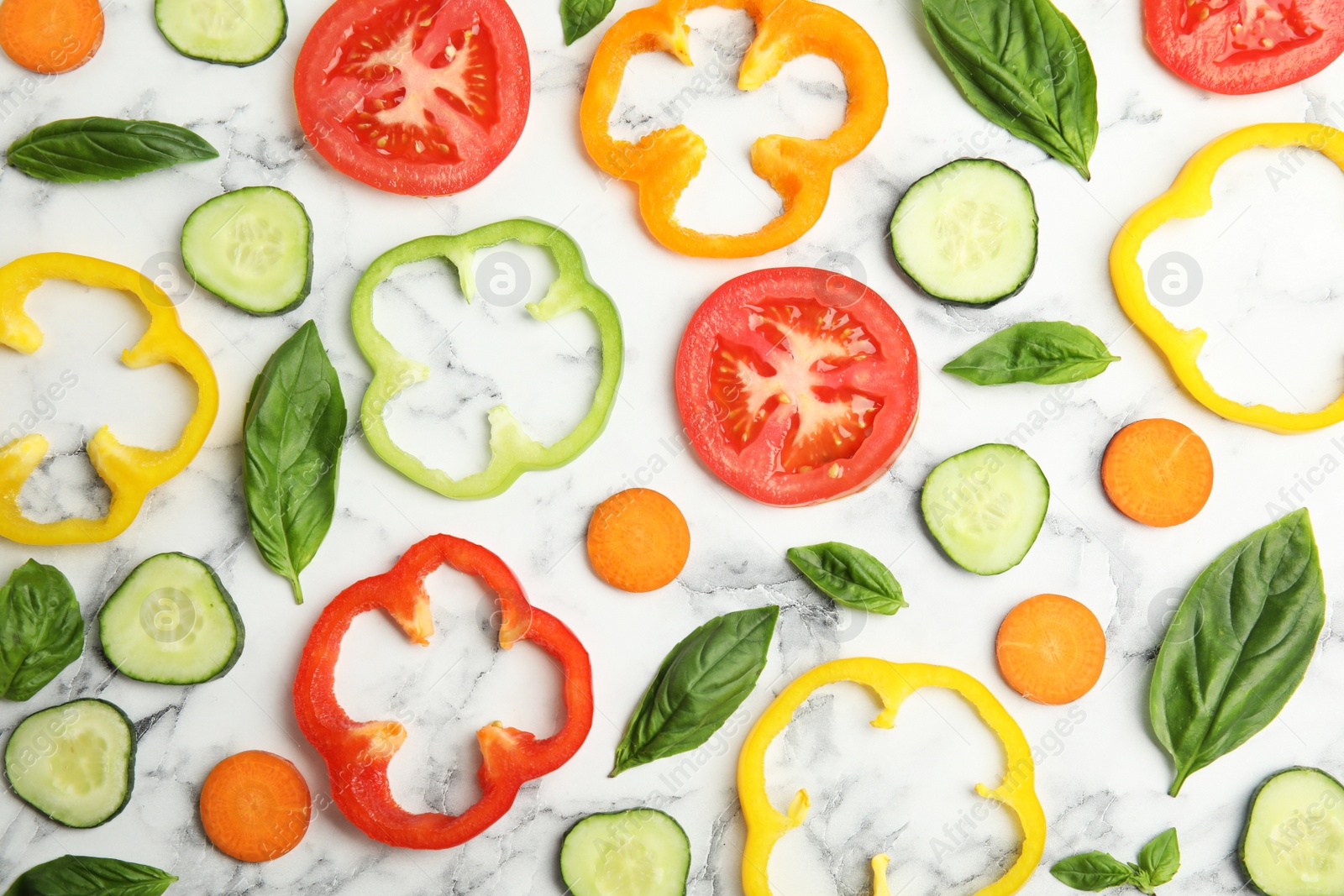 Photo of Flat lay composition with fresh salad ingredients on white marble table