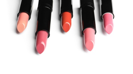 Photo of Different lipsticks on white background. Cosmetic product