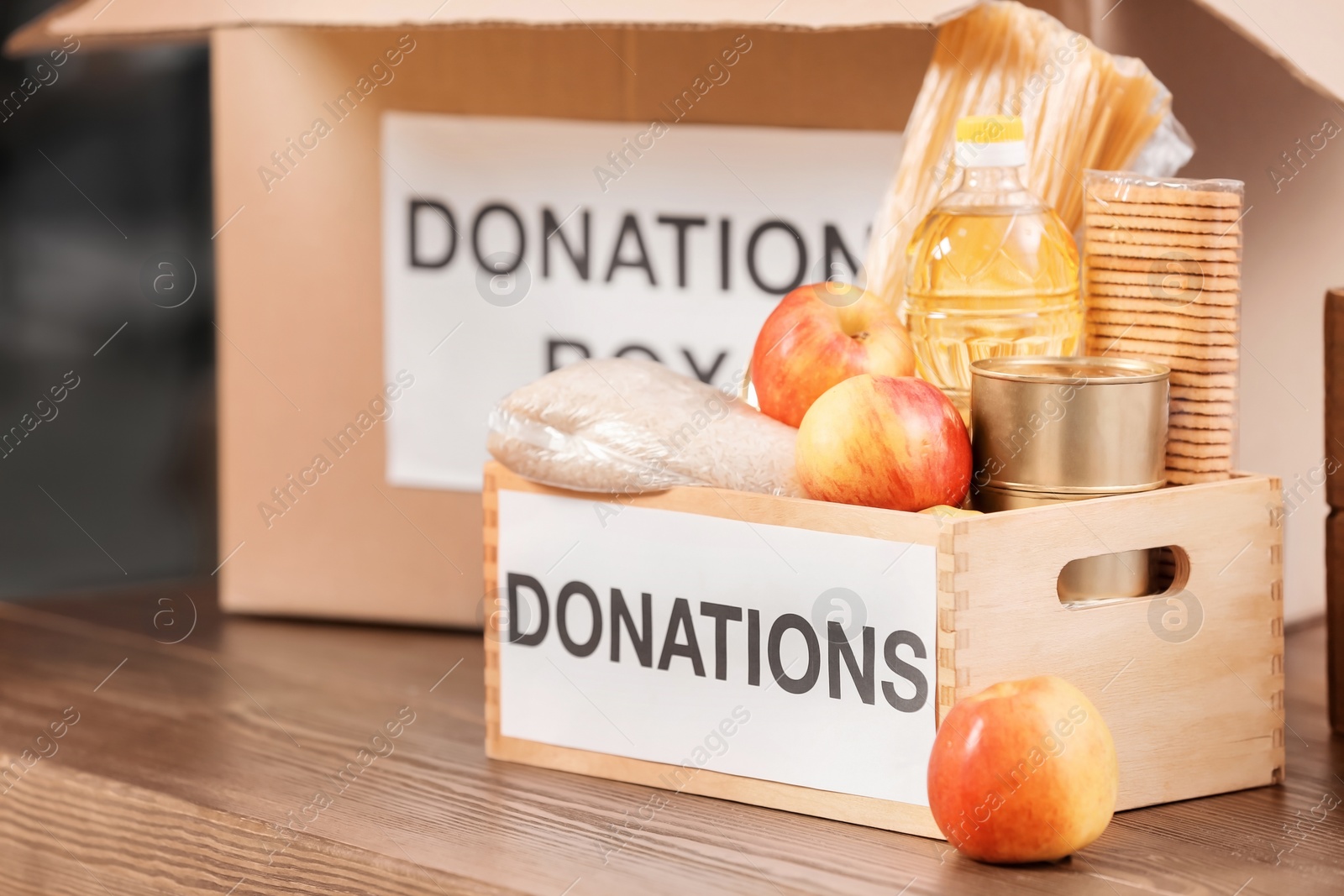 Photo of Donation box with products on table indoors