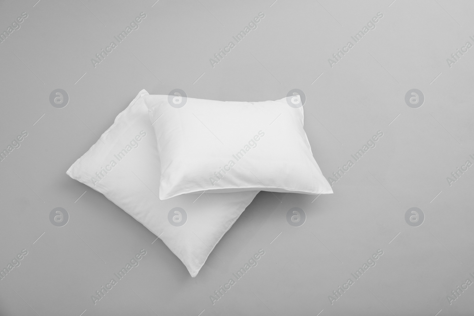 Photo of Clean soft bed pillows on grey background, top view