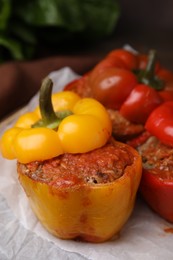 Photo of Delicious stuffed bell peppers served on table, closeup