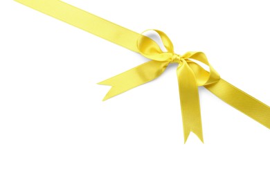 Photo of Yellow satin ribbon with bow on white background, top view