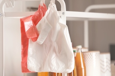 Photo of Many plastic bags on rack with products indoors. Space for text