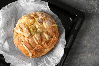 Photo of Freshly baked bread with tofu cheese on grey table, top view