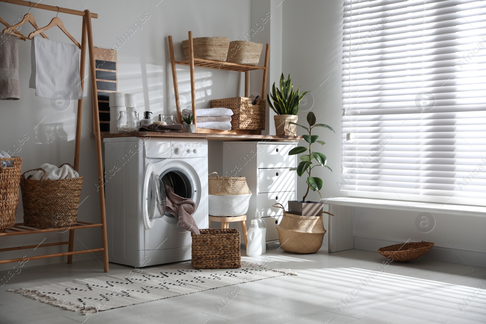 Photo of Stylish bathroom interior with modern washing machine