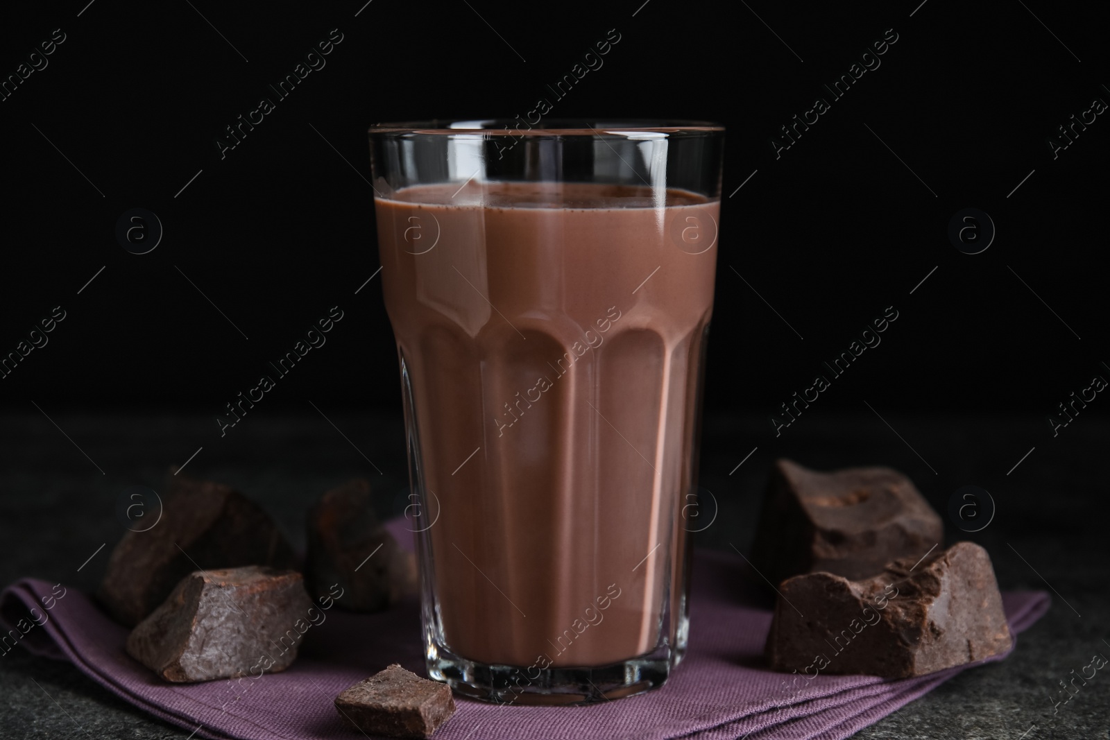 Photo of Delicious chocolate milk in glass on grey table