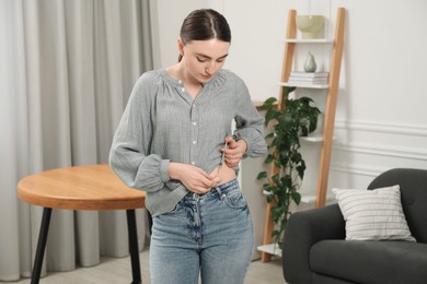 Photo of Diabetes. Woman making insulin injection into her belly at home