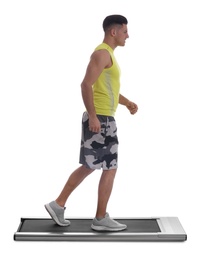 Sporty man using walking treadmill on white background