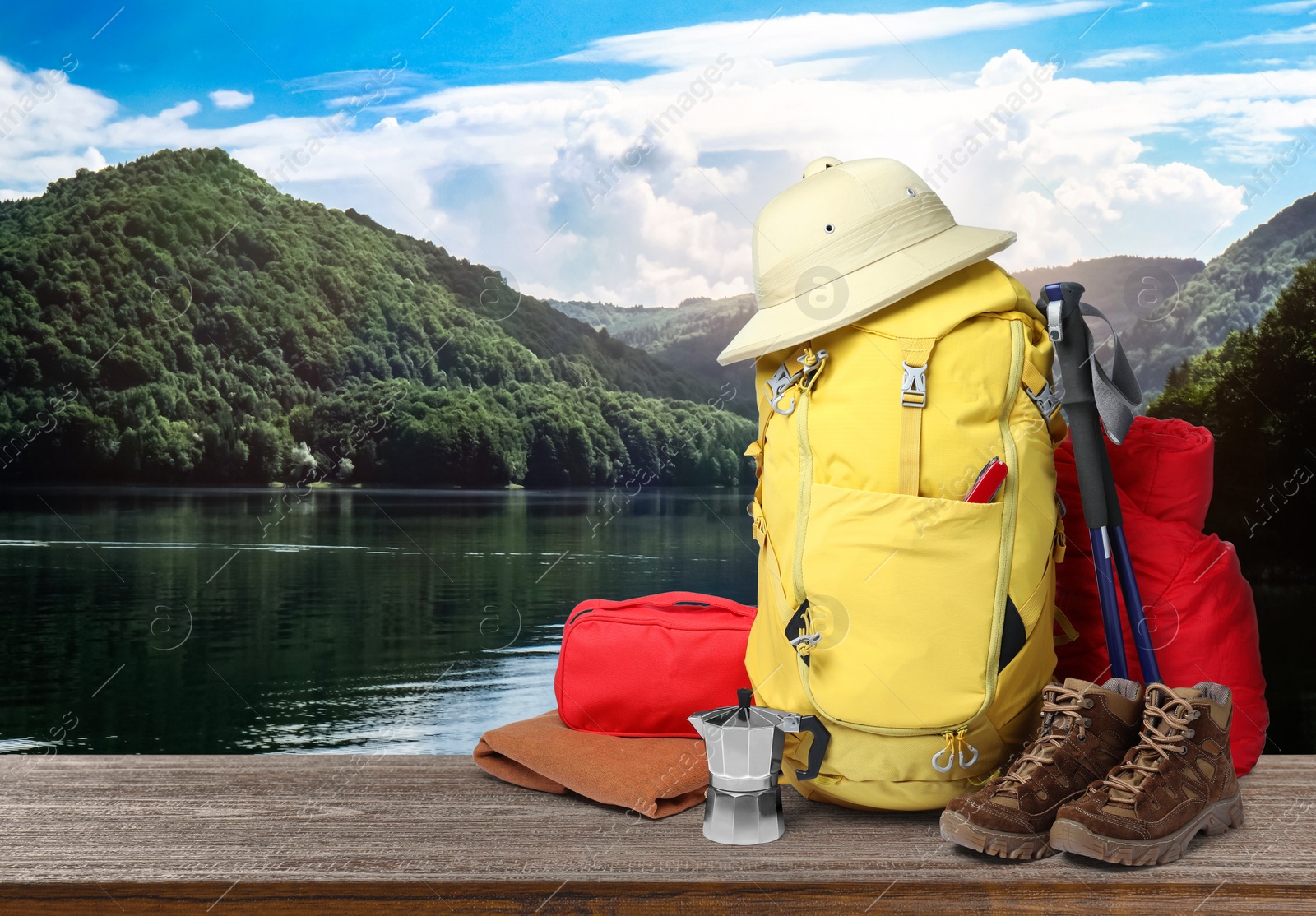 Image of Camping equipment for tourist on wooden surface and beautiful view of mountain landscape