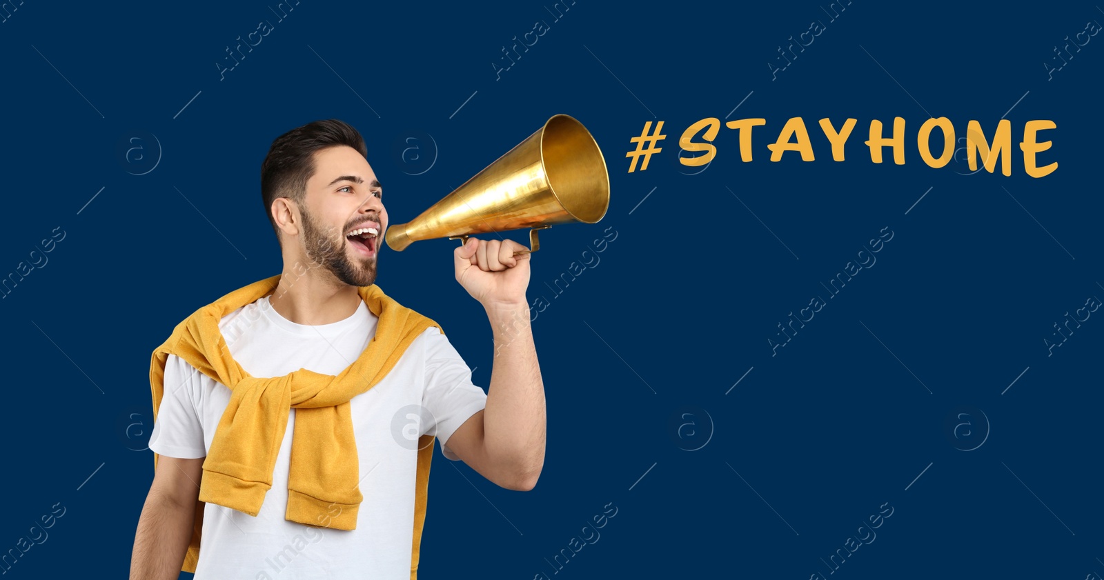 Image of Young man with megaphone on blue background. Stay at home during coronavirus outbreak 