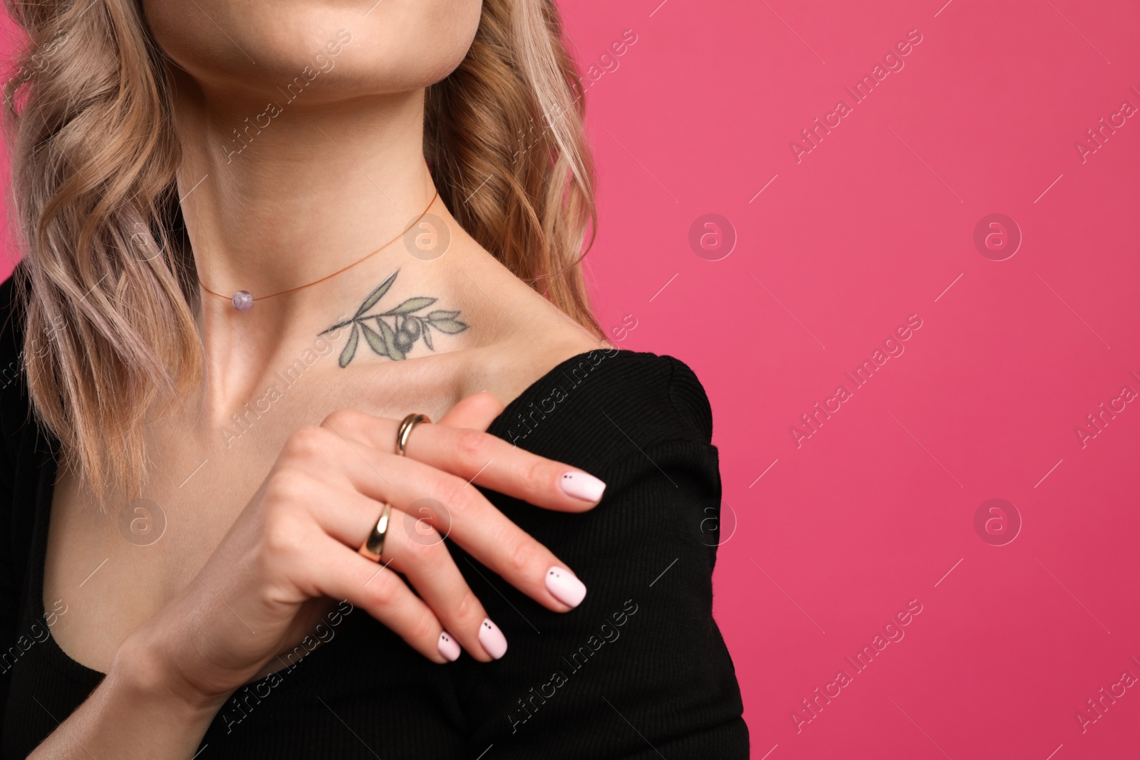 Photo of Beautiful woman with tattoo on body against pink background, closeup. Space for text