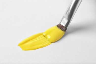 Photo of Brush with color paint and stroke on white background