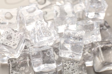 Photo of Melting ice cubes with water drops as background, closeup