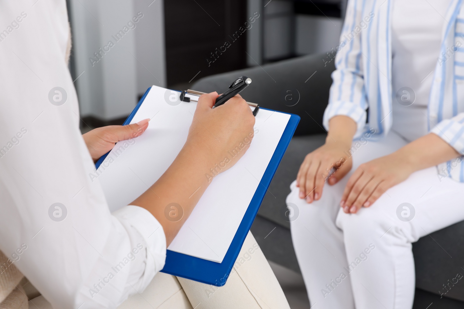 Photo of Professional psychologist working with woman in office, closeup