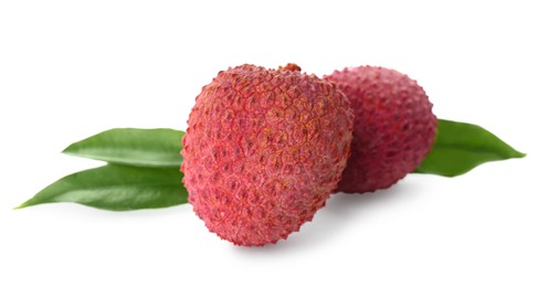 Fresh ripe lychees with green leaves on white background