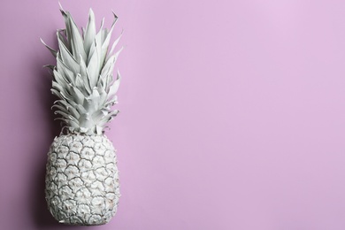 Photo of White pineapple on light background, top view with space for text. Creative concept