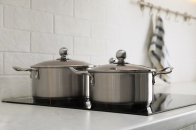 New clean pots on cooktop in kitchen