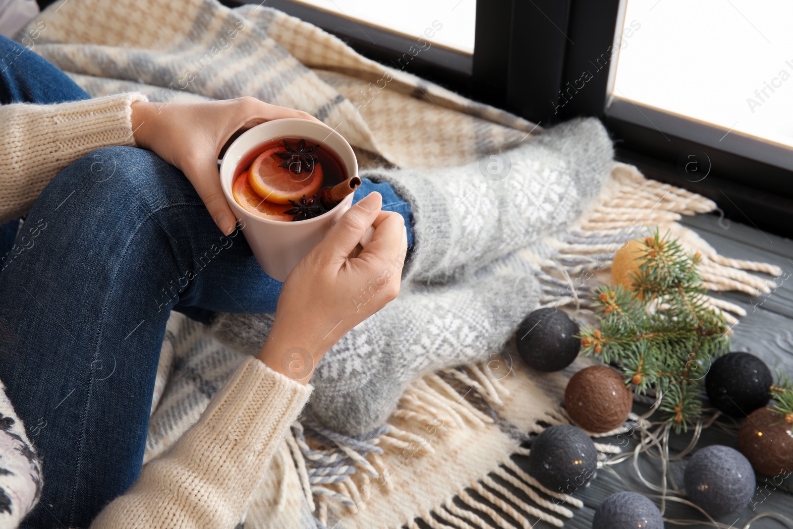 Photo of Woman relaxing with hot winter drink near window. Cozy season